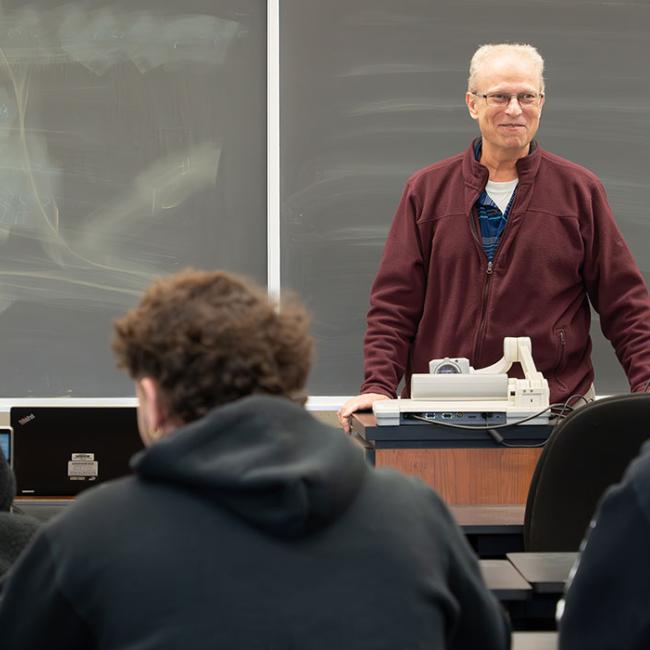 Christopher Scalzo, professor of business at SUNY Morrisville, teaches in his Morrisville classroom.