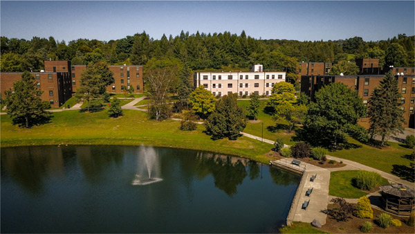 pond with fountain from above, with buildings and trees in the background