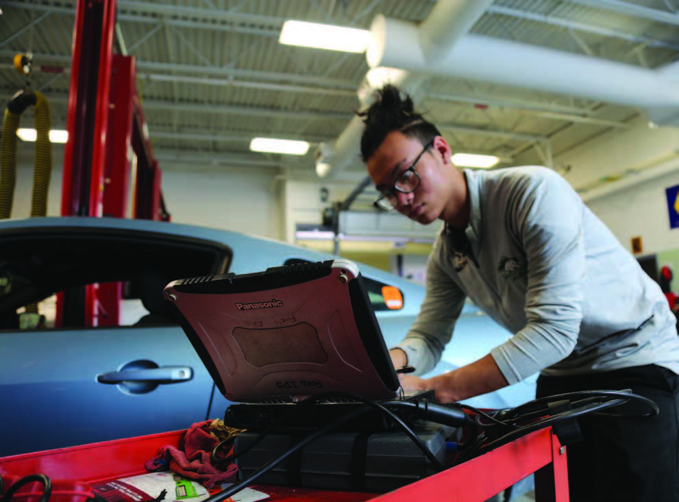 A student works on a car