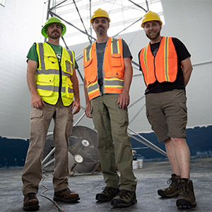 From left: professors Phil Hofmeyer, Ben Ballard and Ryan Quinn stand in front of a climbing tower in the new ACET Center.