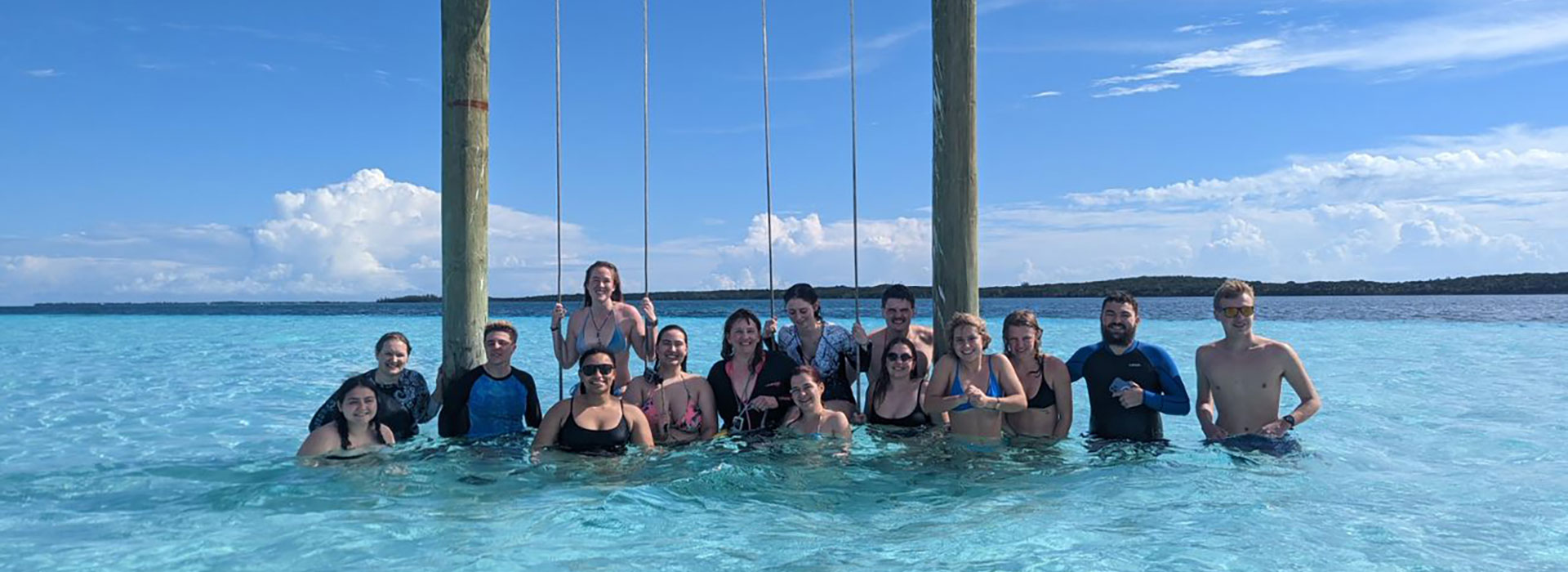 Students pose at the Stingray sandbar swings in the Bahamas.