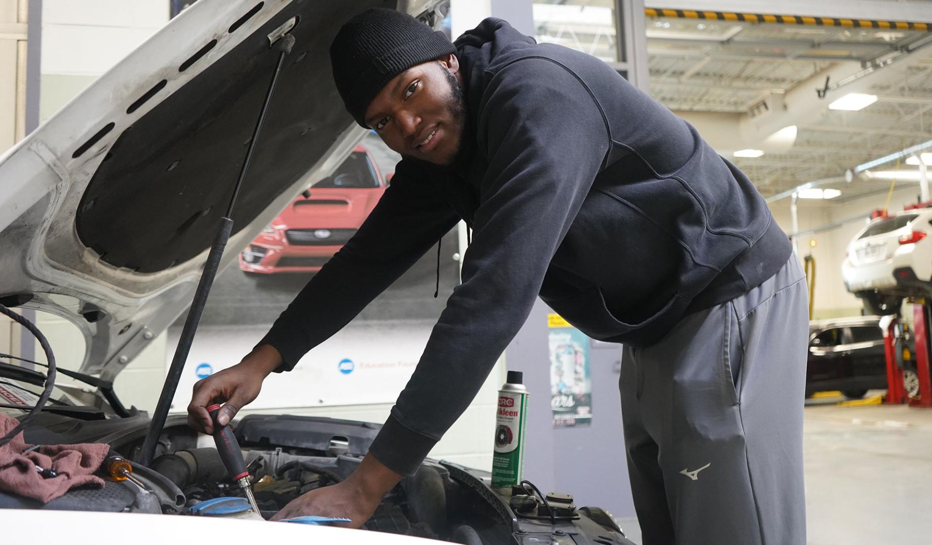 A student works on a car in Matt Polak's MOPAR program.