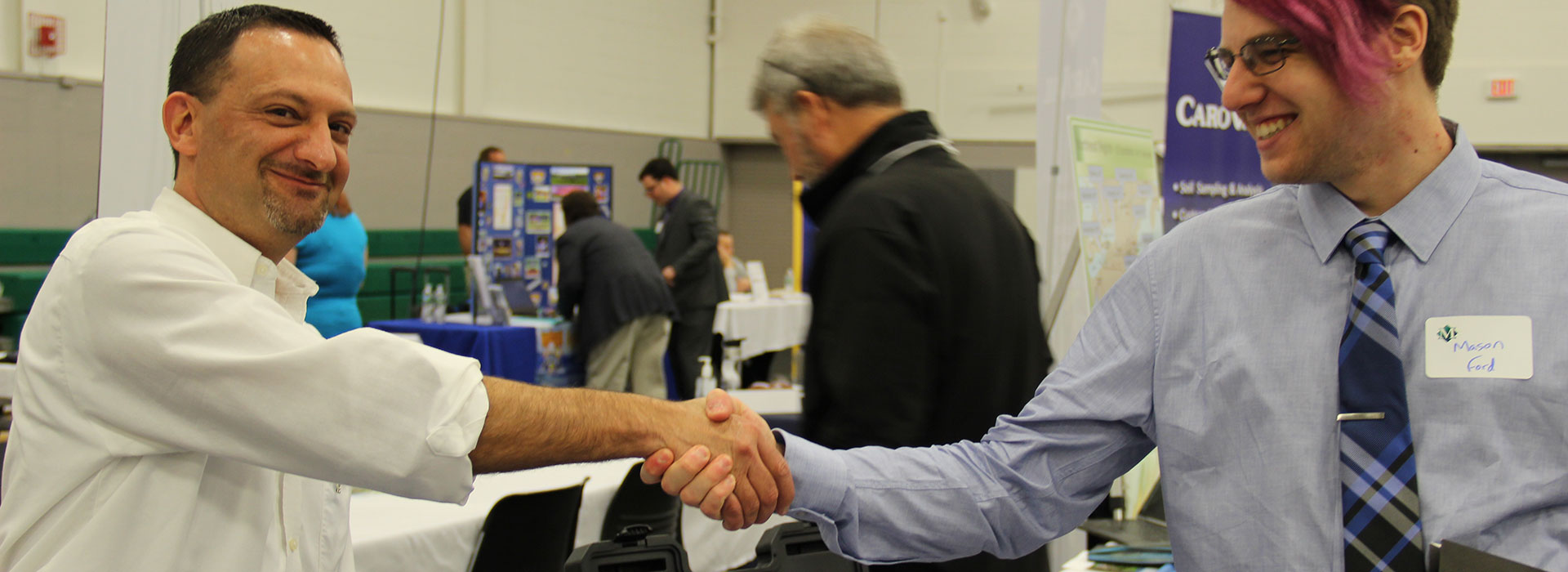 Shaking hands at a career fair.