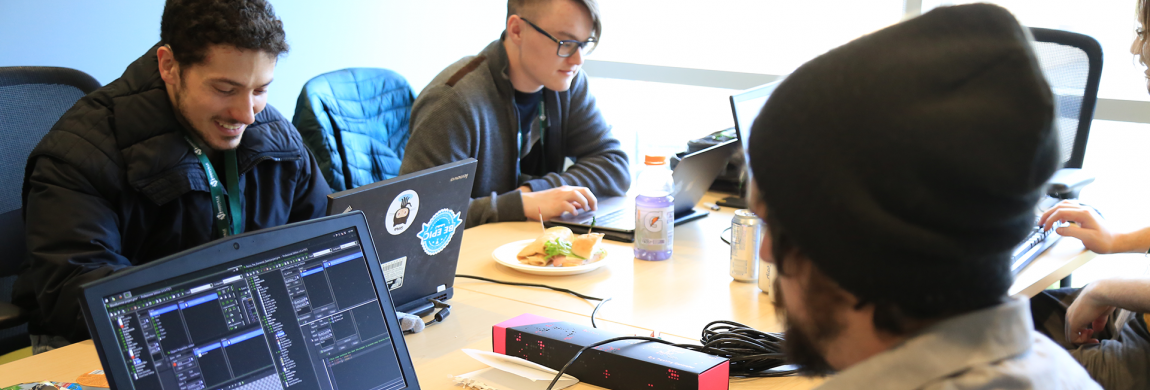 Four people at their computers.