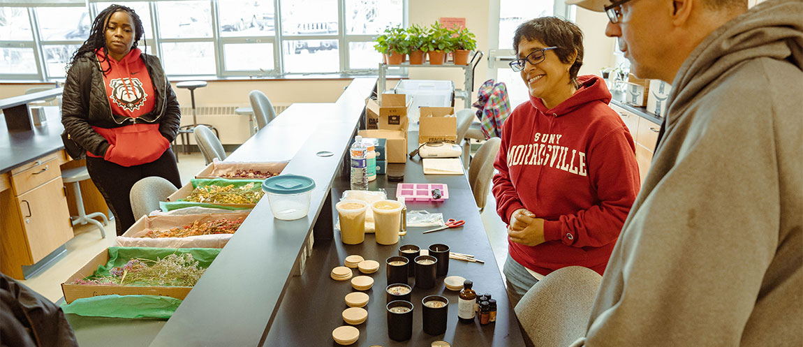 Students use pressed oils to create scented candles.