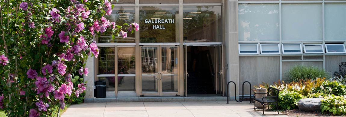 flowers bloom in front of galbreath hall