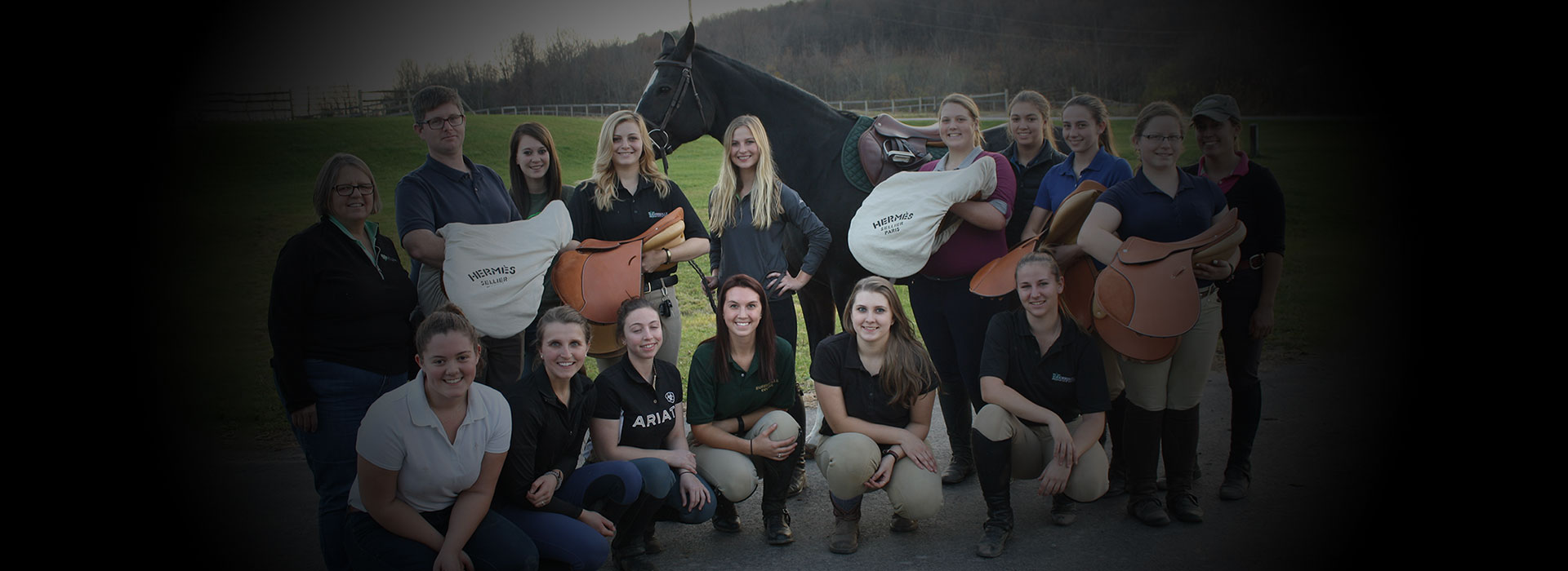 Jimmy Sardelli poses with equine students after donating saddles to the college’s equine programs, while working at Hermés USA.