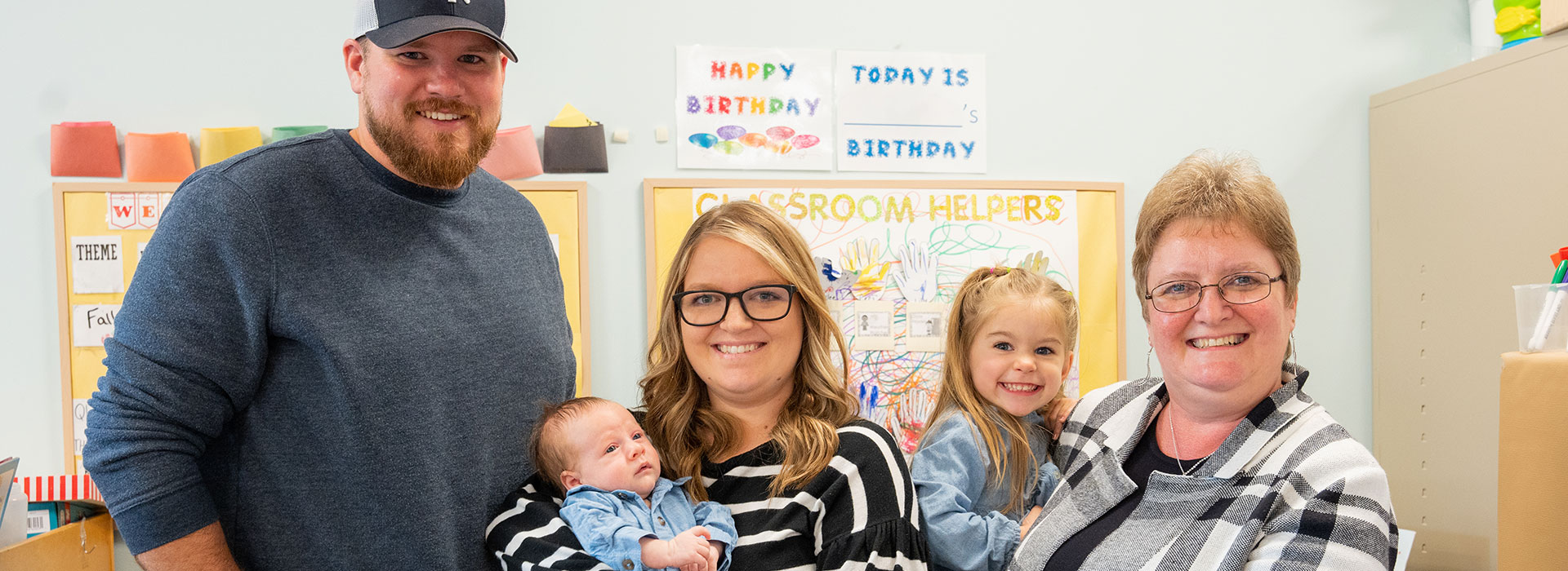 Wendy Groves (right), holds her granddaughter, Gracie, while standing beside her daughter, Taylor Massett, and grandson, Connor (center), and son-in-law, Cody Massett (left).