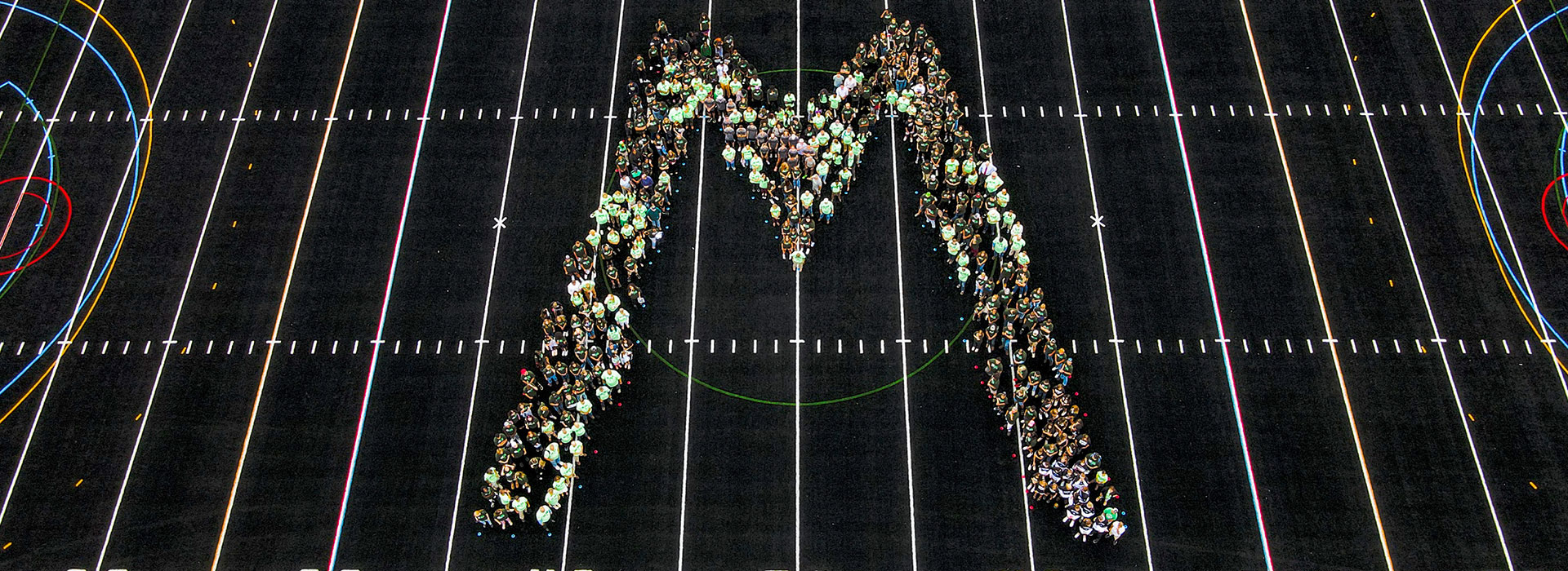 Students, faculty and staff gather on the athletic field to ring in the new semester.