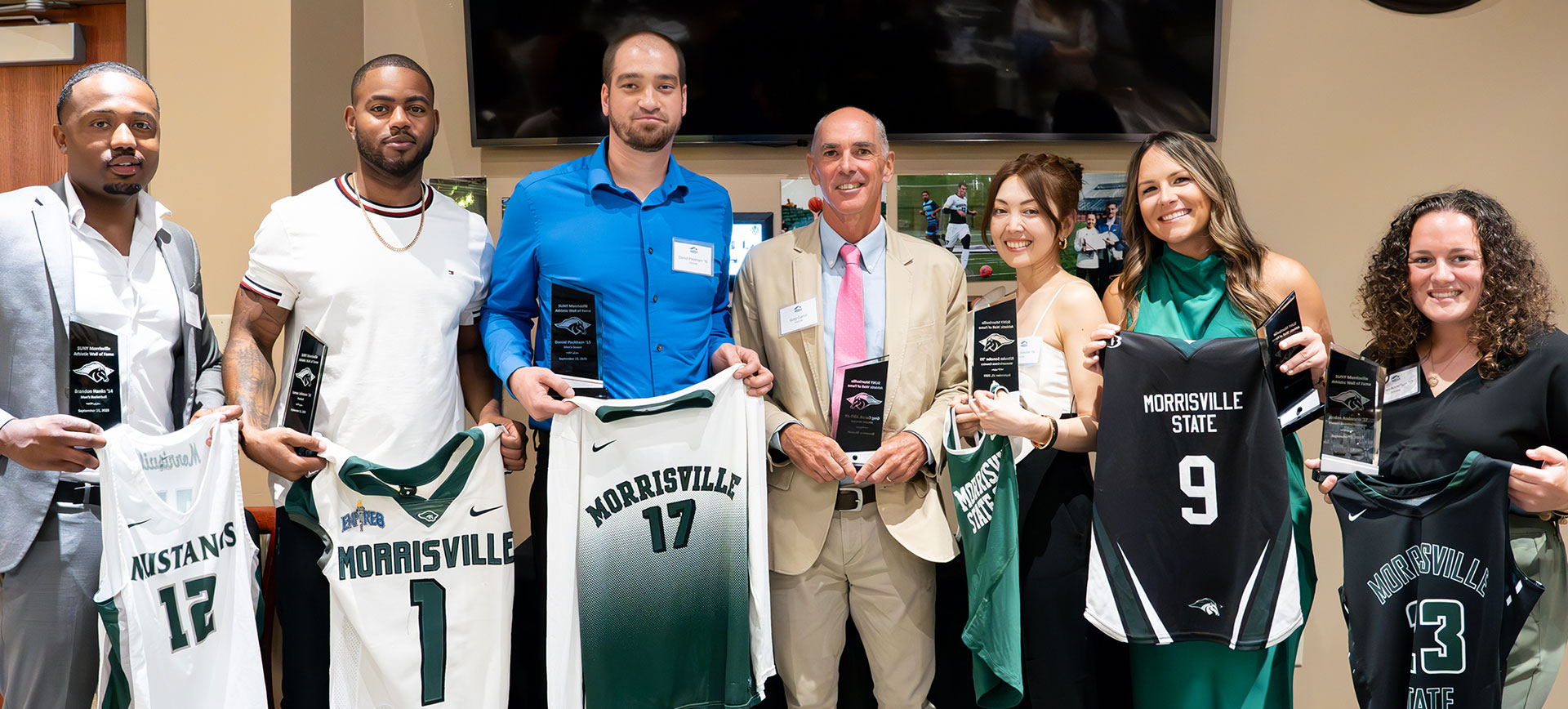 From left: Brandon Hanks '14, Lemar Johnson '14, Daniel Peckham '16, Greg Carroll, Athletics Director, 2001-19, Ritsuko Sonobe '00, Shelby (Wood) Rosaschi '15, Jordan Anderson '17