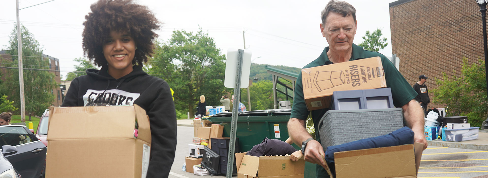 SUNY Morrisville President David Rogers assists Aniyah Smith with moving into her residence hall. 