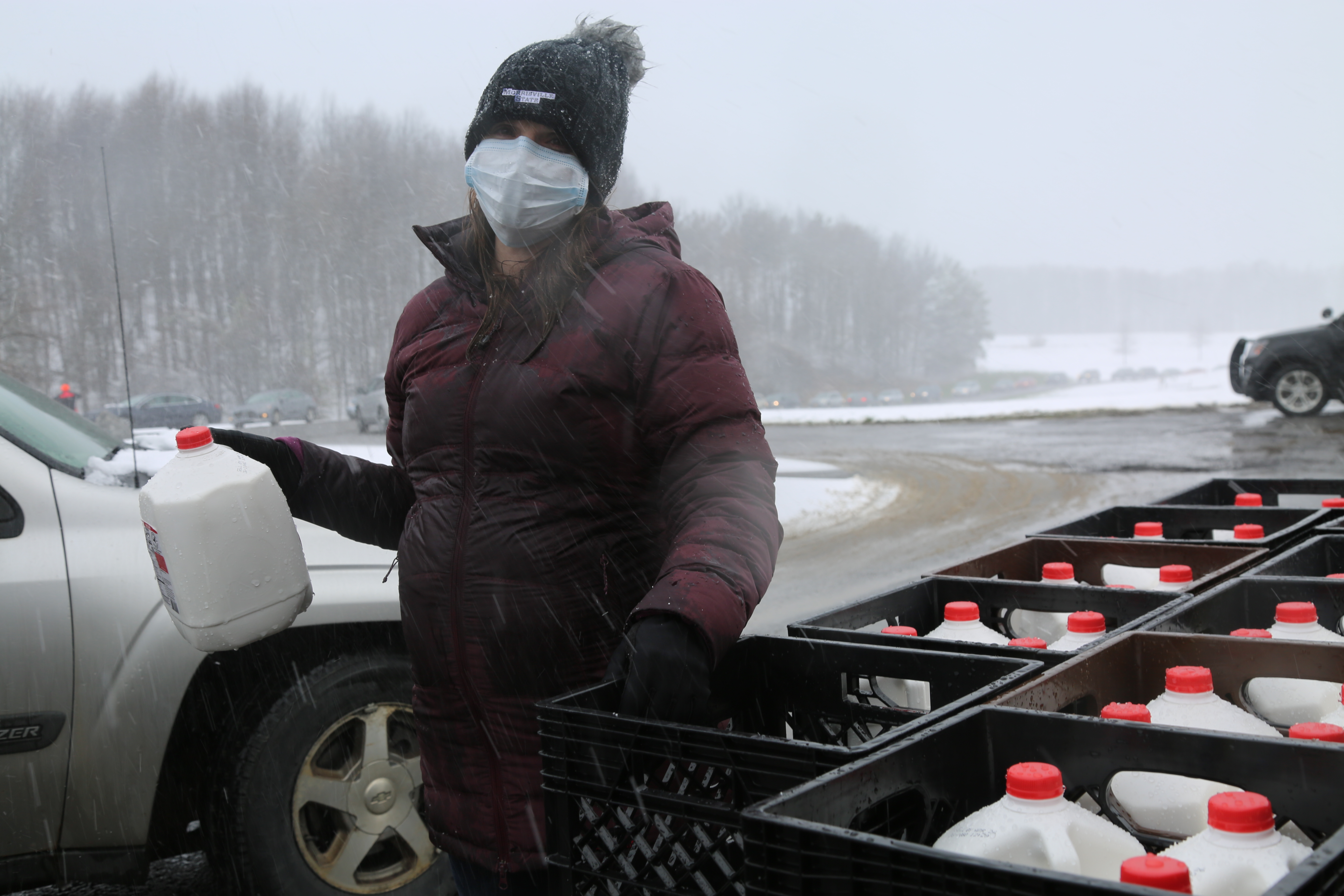Professor Ashley Marshall distributes milk during a dairy drive-thru.