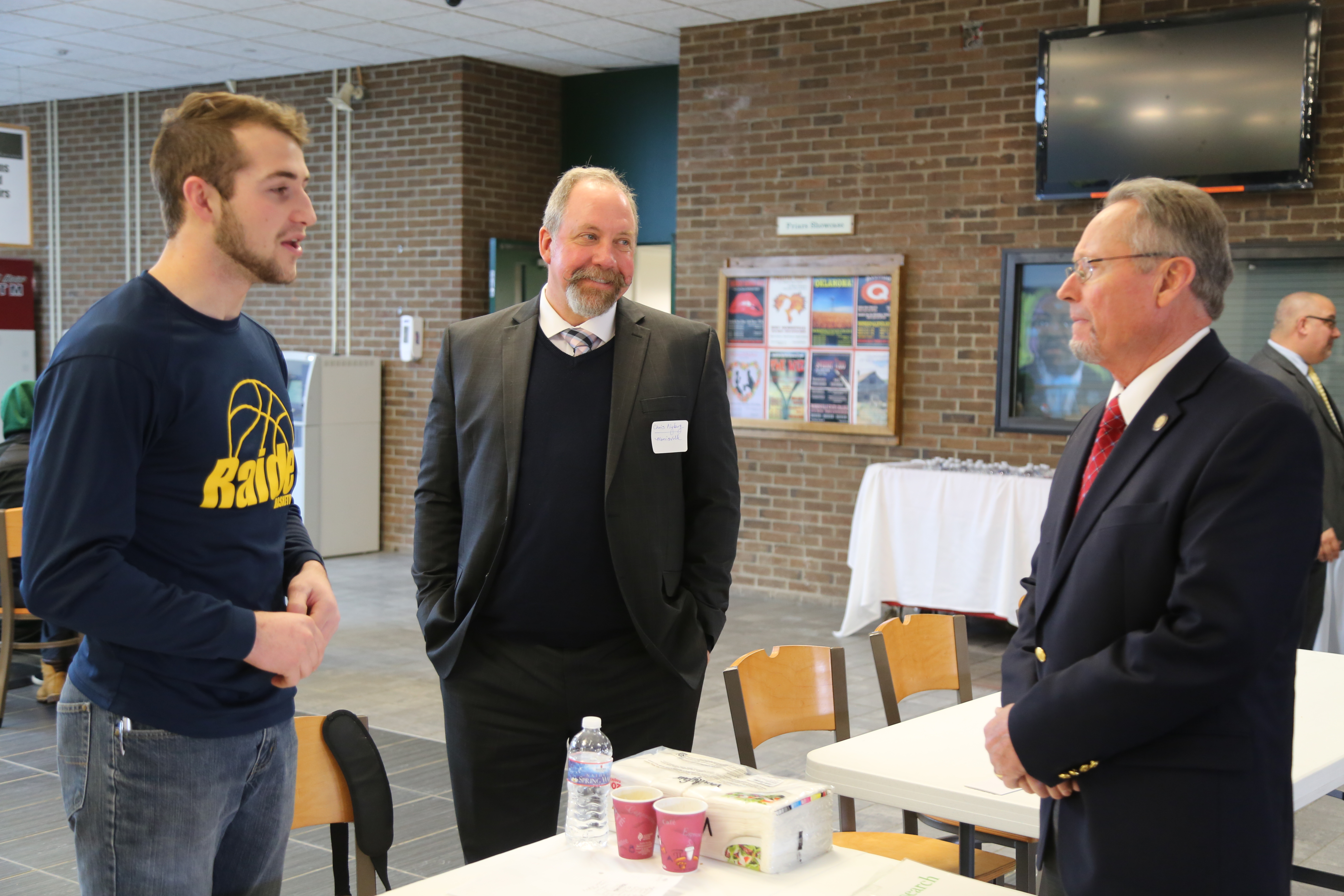 Richard Ball, commissioner of the New York State Department of Agriculture and Markets, speaks with Jacob Kline, an agricultural business student from Myerstown, Pennsylvania, and Christopher Nyberg, Dean of the School of Agriculture and Natural Resources.
