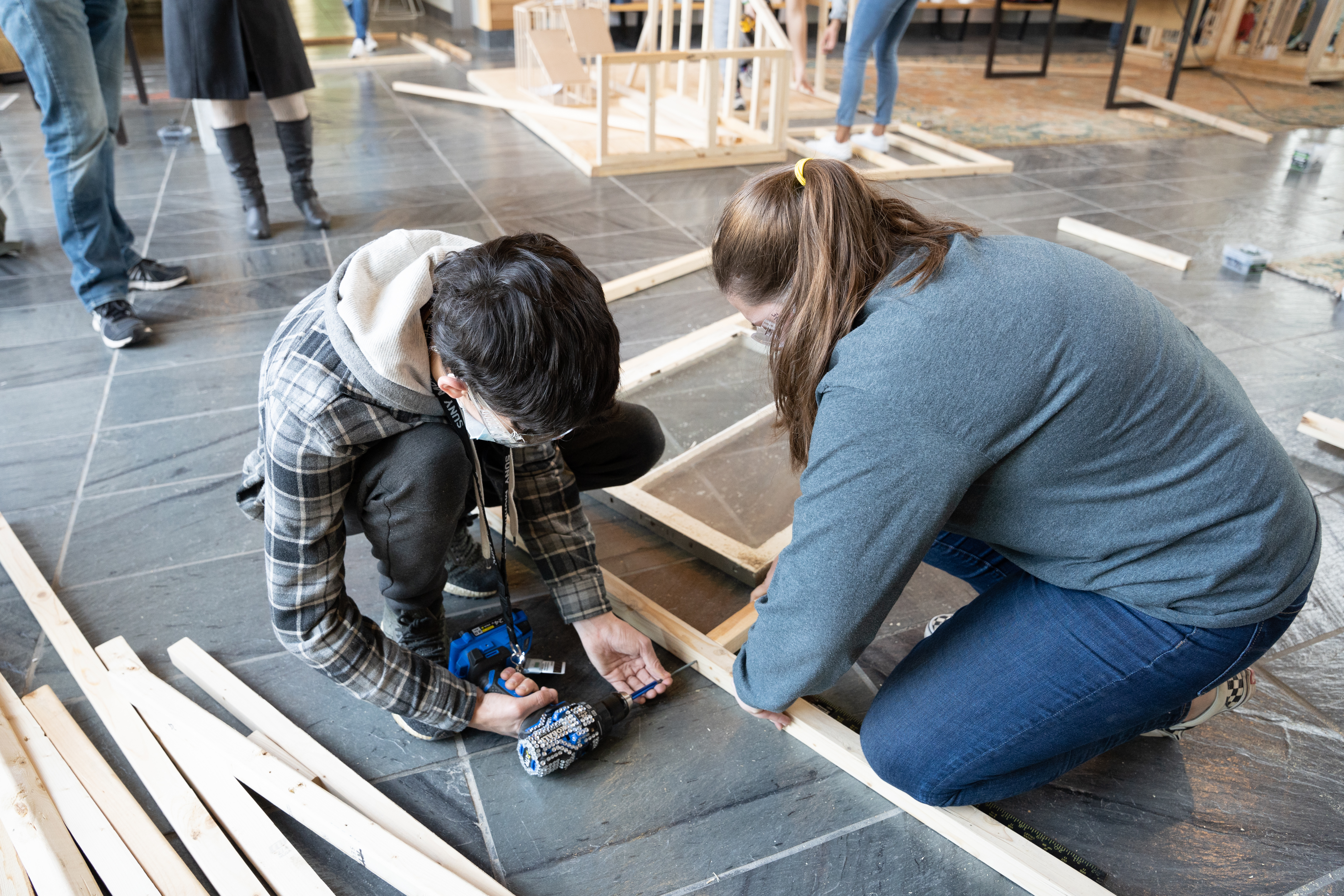 From left, architectural studies & design students Dante Kraft and Hannah Lake work on their team’s person pod.