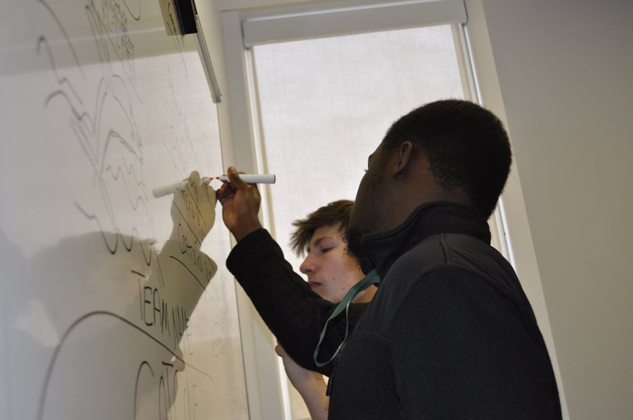 Past participants work on creating a video game