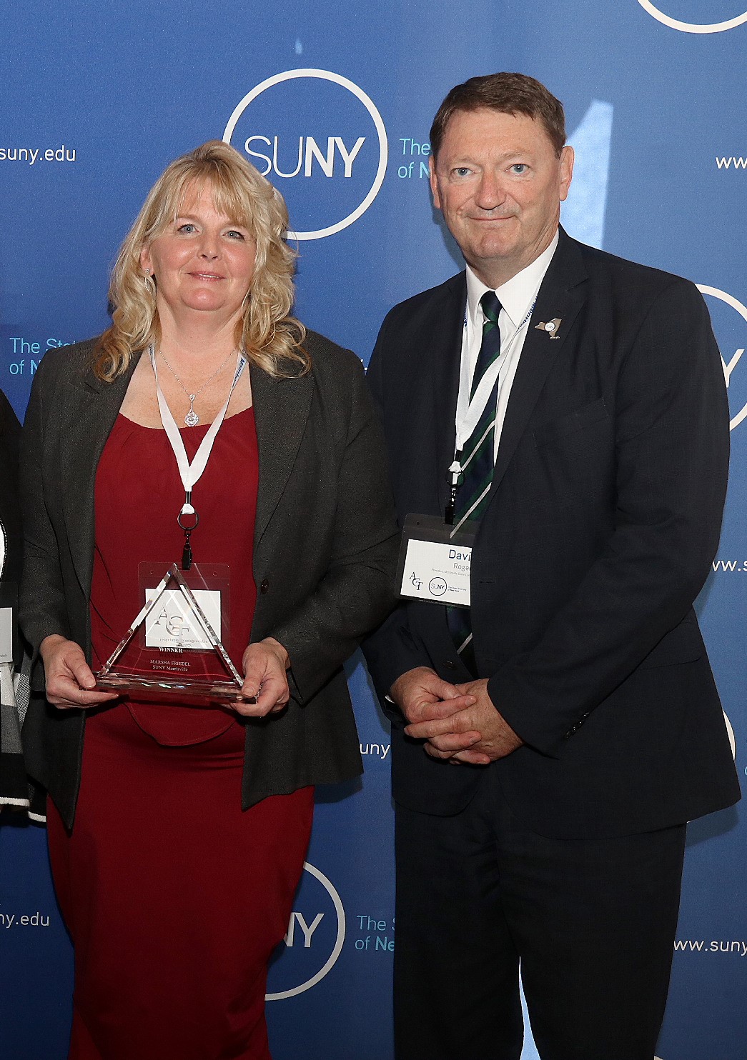 Marsha Friedel poses with President David Rogers after receiving her award.