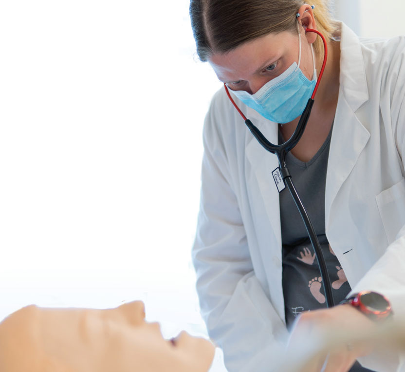 Jessica Miller works with a mannequin in a nursing lab at SUNY Morrisville.