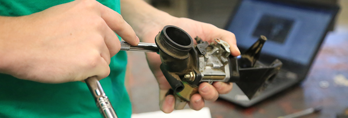 Student working on an engine part