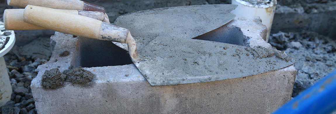 Some trowels resting on a cinderblock