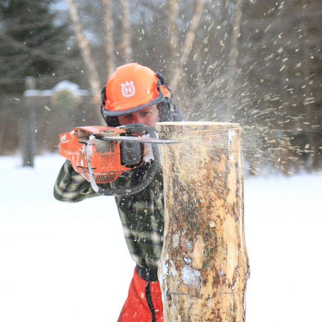 Person wielding chainsaw