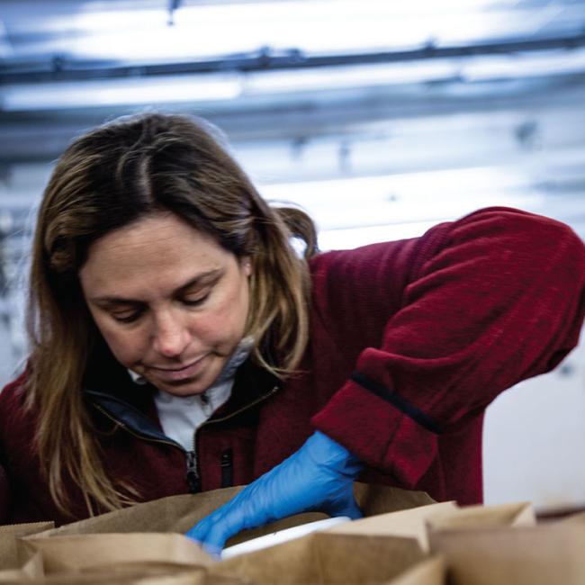Rebecca Werbela fills bags during one of five dairy drive-thru events.