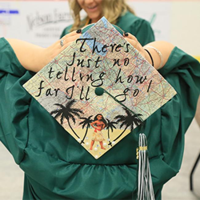 graduating student wearing a decorated cap