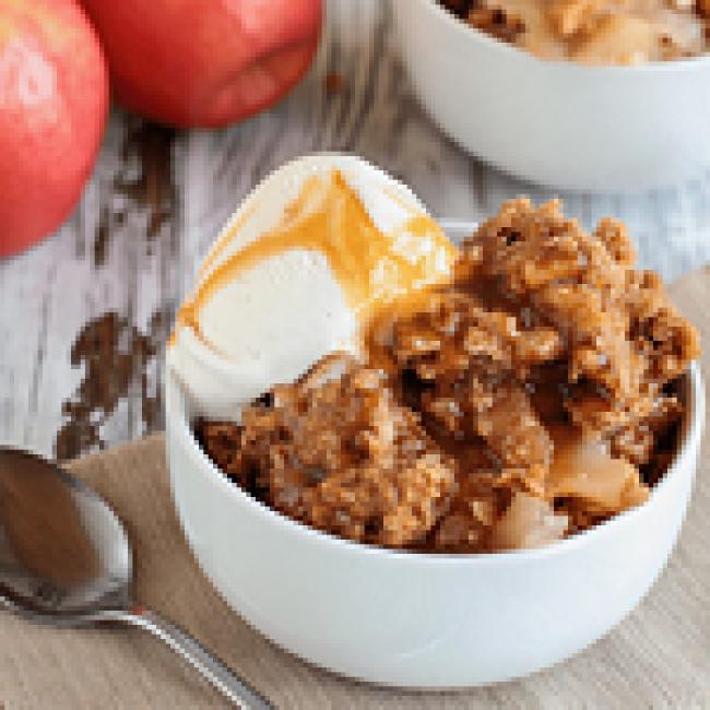 Bowl of Apple Betty with vanilla ice cream