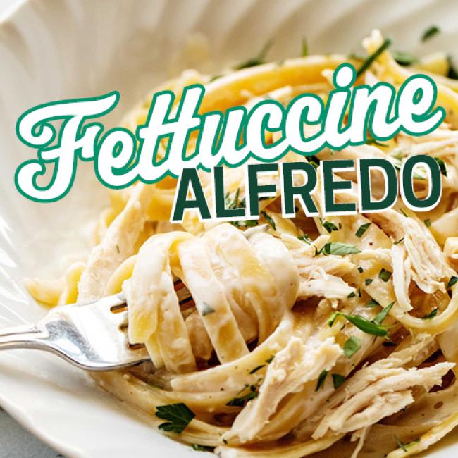 Fork spinning fettuccine alfredo in a bowl