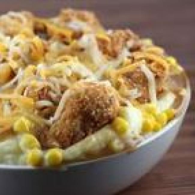 Mashed potato bowl with chicken, corn, cheese, and gravy