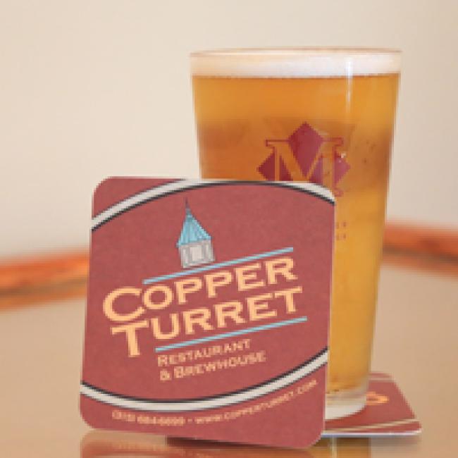 A pint of beer and a coaster from the Copper Turret