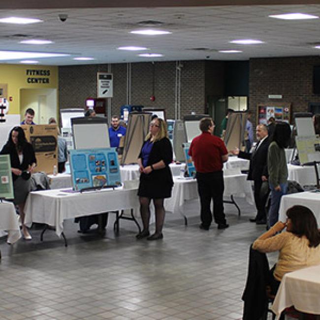 Students, faculty and staff attend an in-person showcase