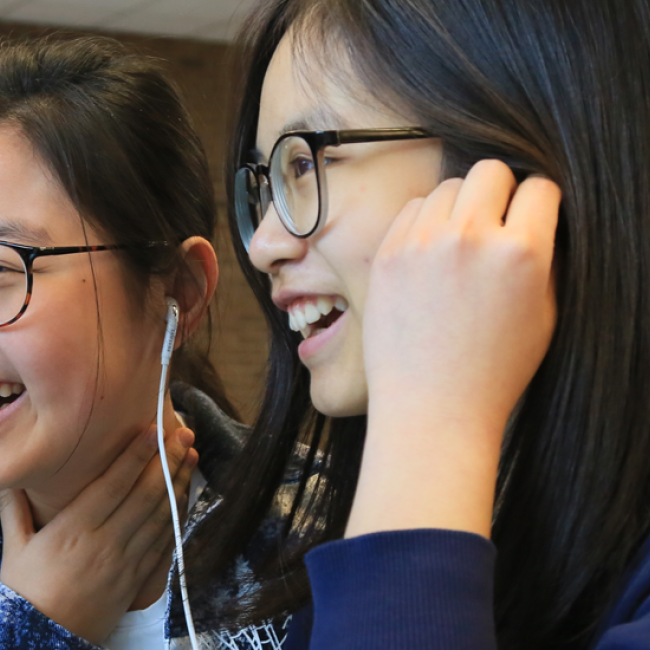Two laughing international students