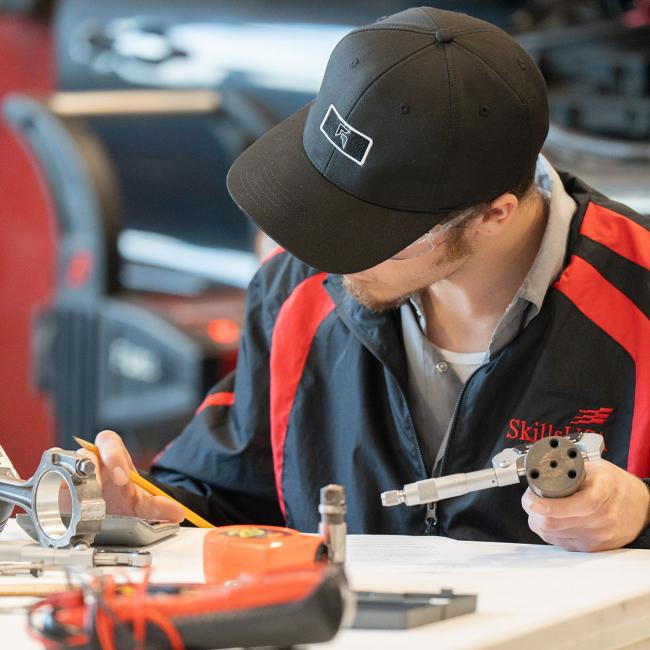 A student works with auto parts during the SkillsUSA competition.