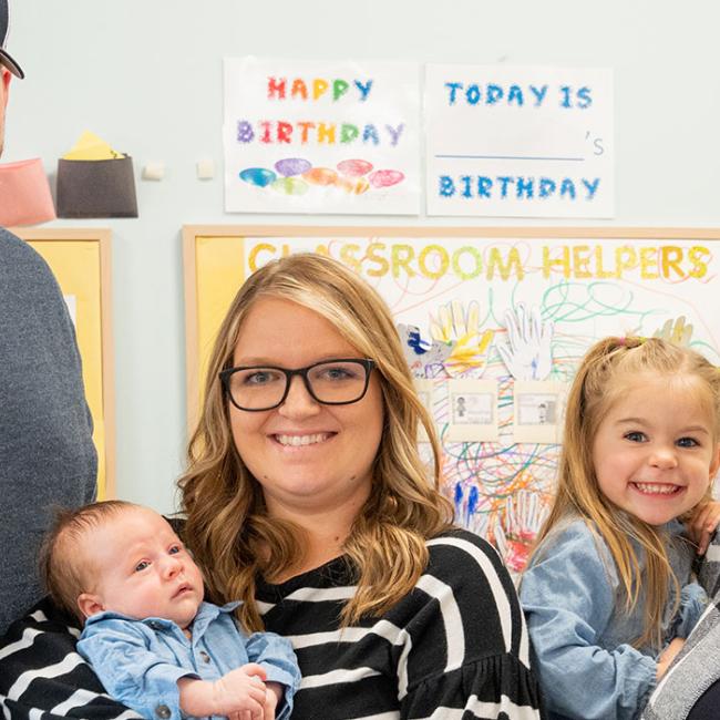 Wendy Groves (right), holds her granddaughter, Gracie, while standing beside her daughter, Taylor Massett, and grandson, Connor (center), and son-in-law, Cody Massett (left).