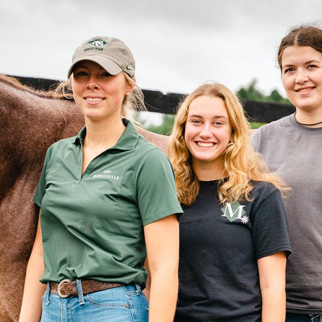 Posing with Finn are, from left, equine students Mak Park,Victoria Eqstein, Carli Potter and Gianna Auriemma.