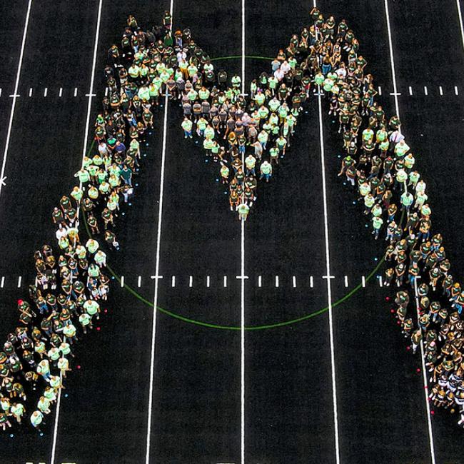 Students, faculty and staff gather on the athletic field to ring in the new semester.