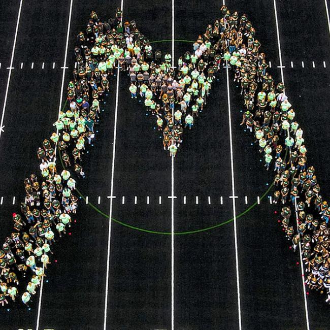 Students, faculty and staff gather on the athletic field to ring in the new semester.