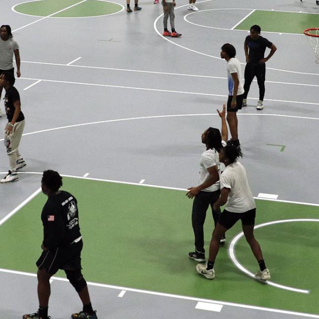 Students play basketball in the new student recreation center.