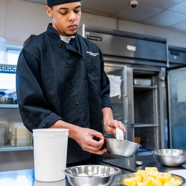 Dillon English mixes ingredients for a pineapple cake 