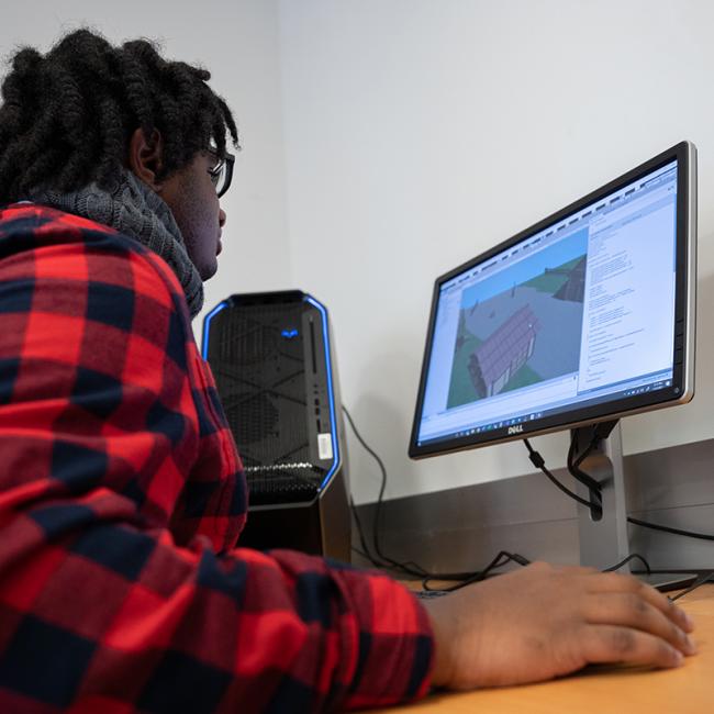 A student works within game engine to create interactive world.