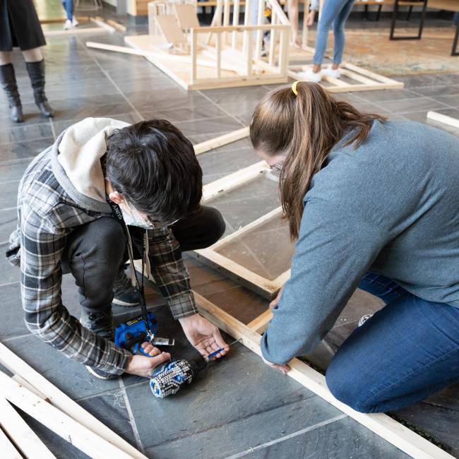 From left, architectural studies & design students Dante Kraft and Hannah Lake work on their team’s person pod. 