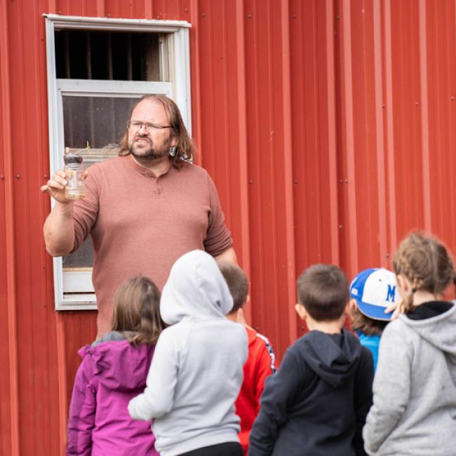 Professor giving presentation to children