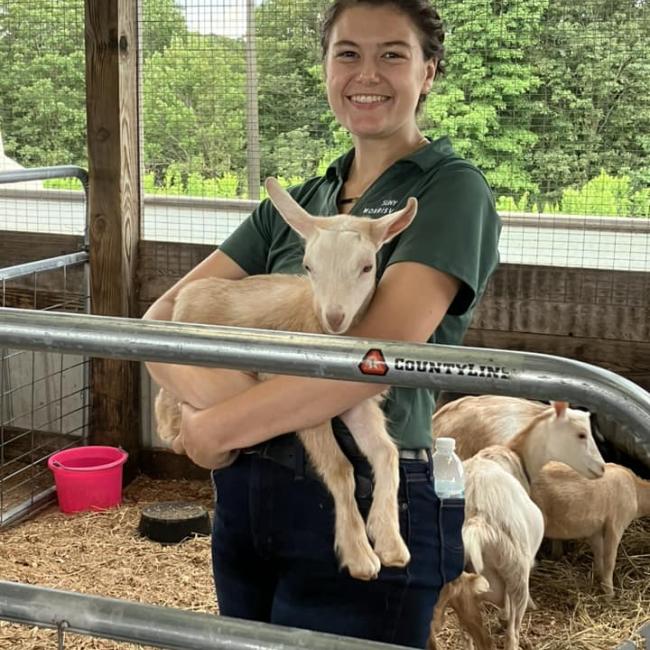 Carrianne Bush shows off a goat during Open Farm Day at SUNY Morrisville