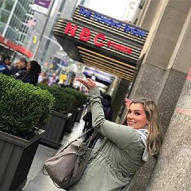 Rachel Jackson is pictured outside the famous NBC sign in New York City.