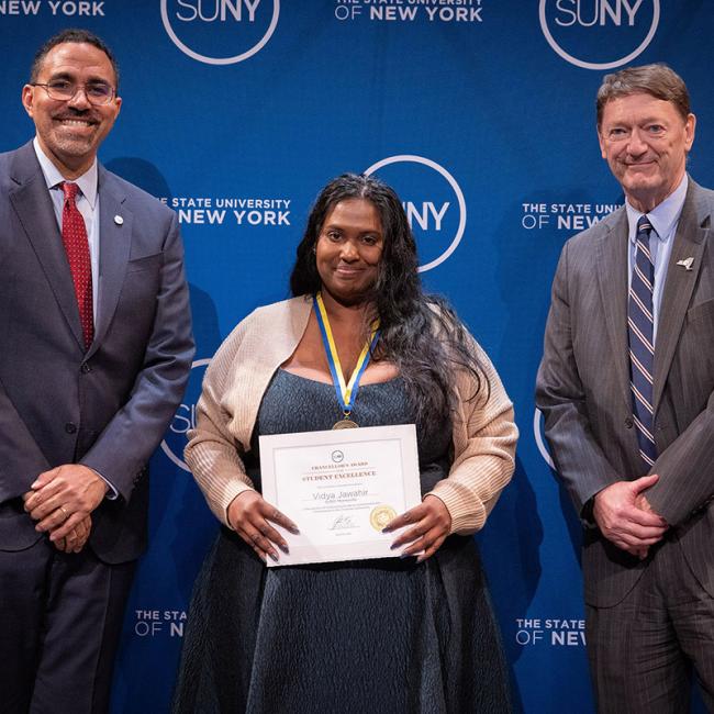 Vidya Jawahir poses with her Chancellor's Award for Student Excellence