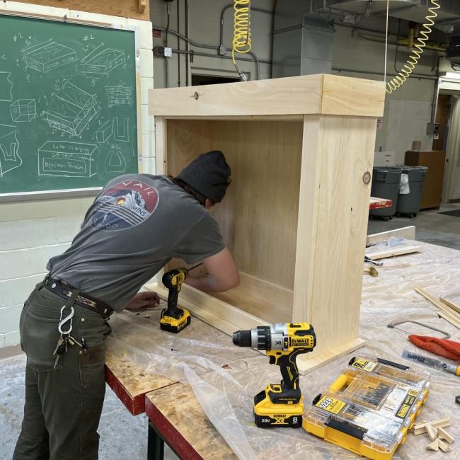 A wood products technology student works on a project