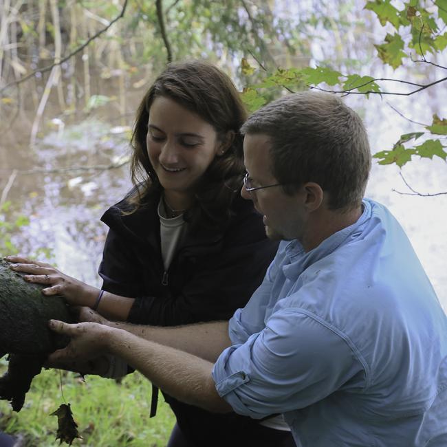 SUNY Morrisville assistant professor Eric Diefenbacher shows renewable resources technology student Kate Augustine (Saranac Lake) how to hold a common snapping turtle. 