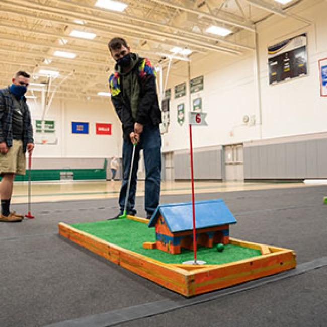 Participants enjoy miniature golf, one of many activities during Giving Day.