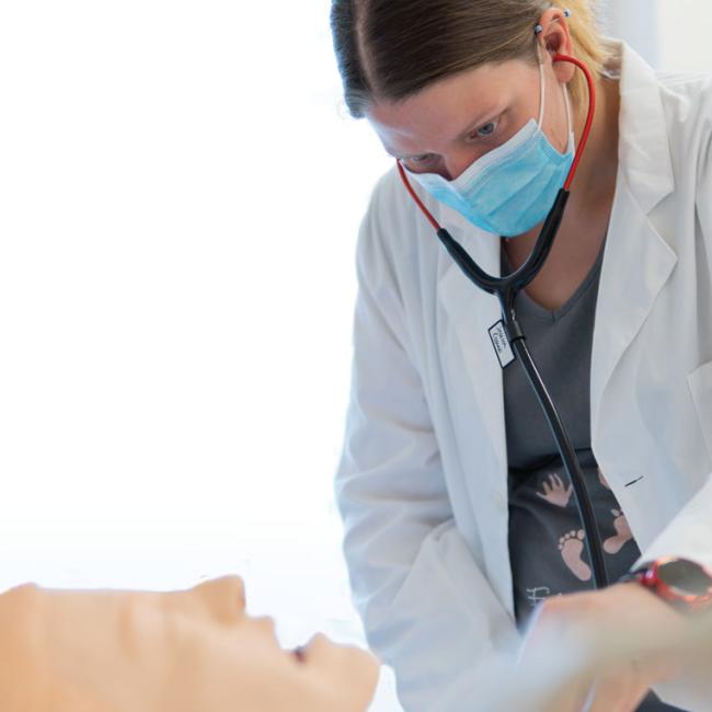 Jessica Miller works with a mannequin in a nursing lab at SUNY Morrisville.