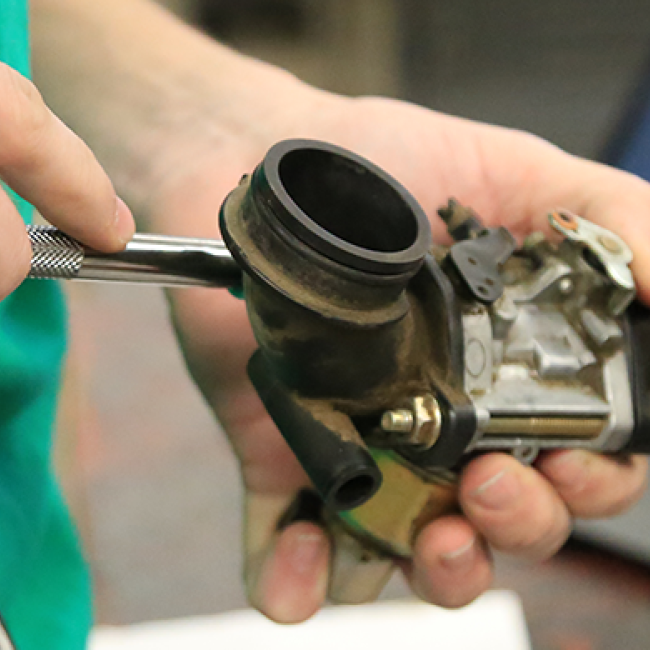 Student working on an engine part
